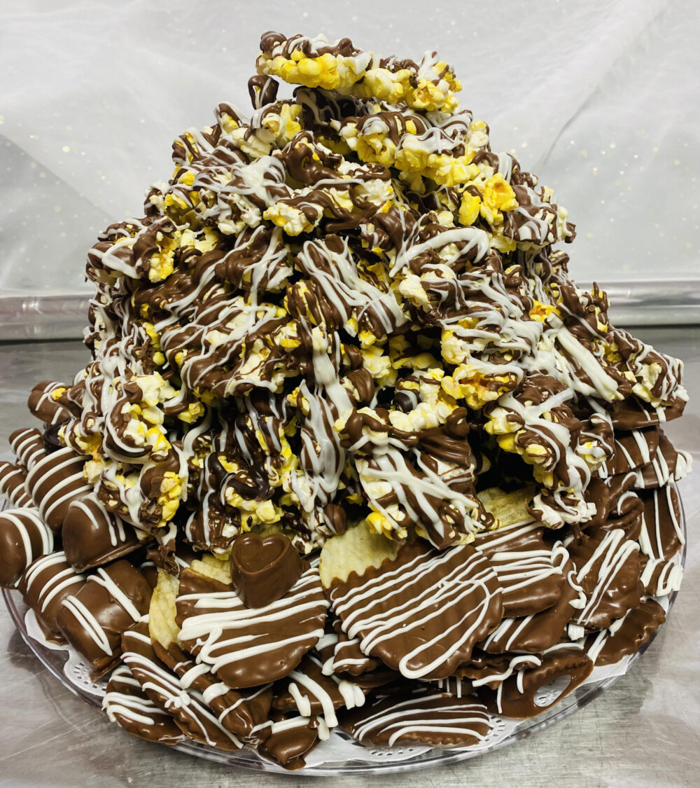 A chocolate cake with white and yellow frosting.