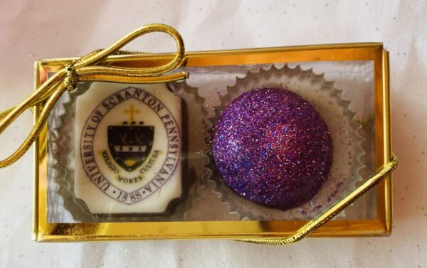 A purple ball of chocolate in a box.