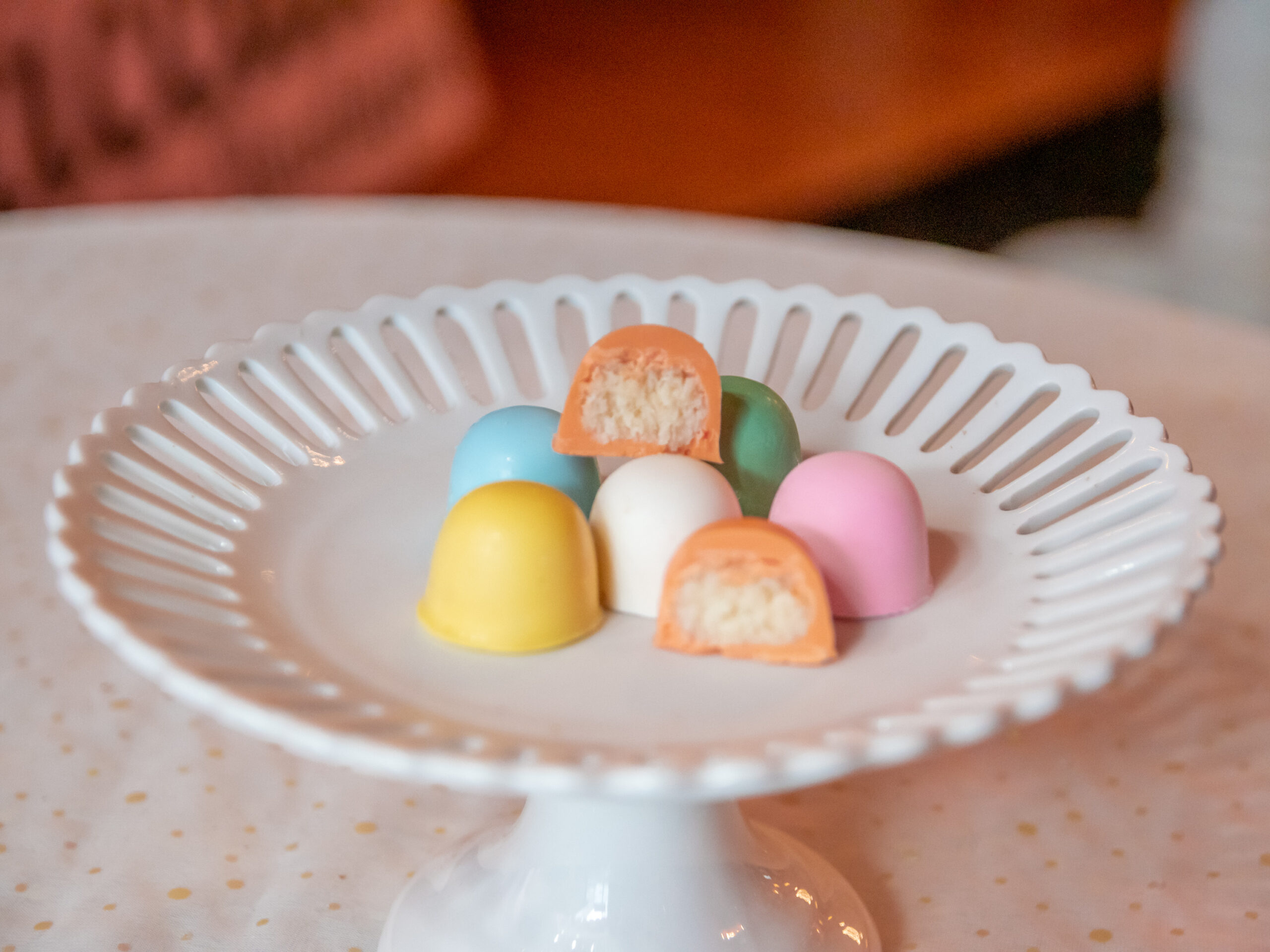 A white plate with some different colored candies