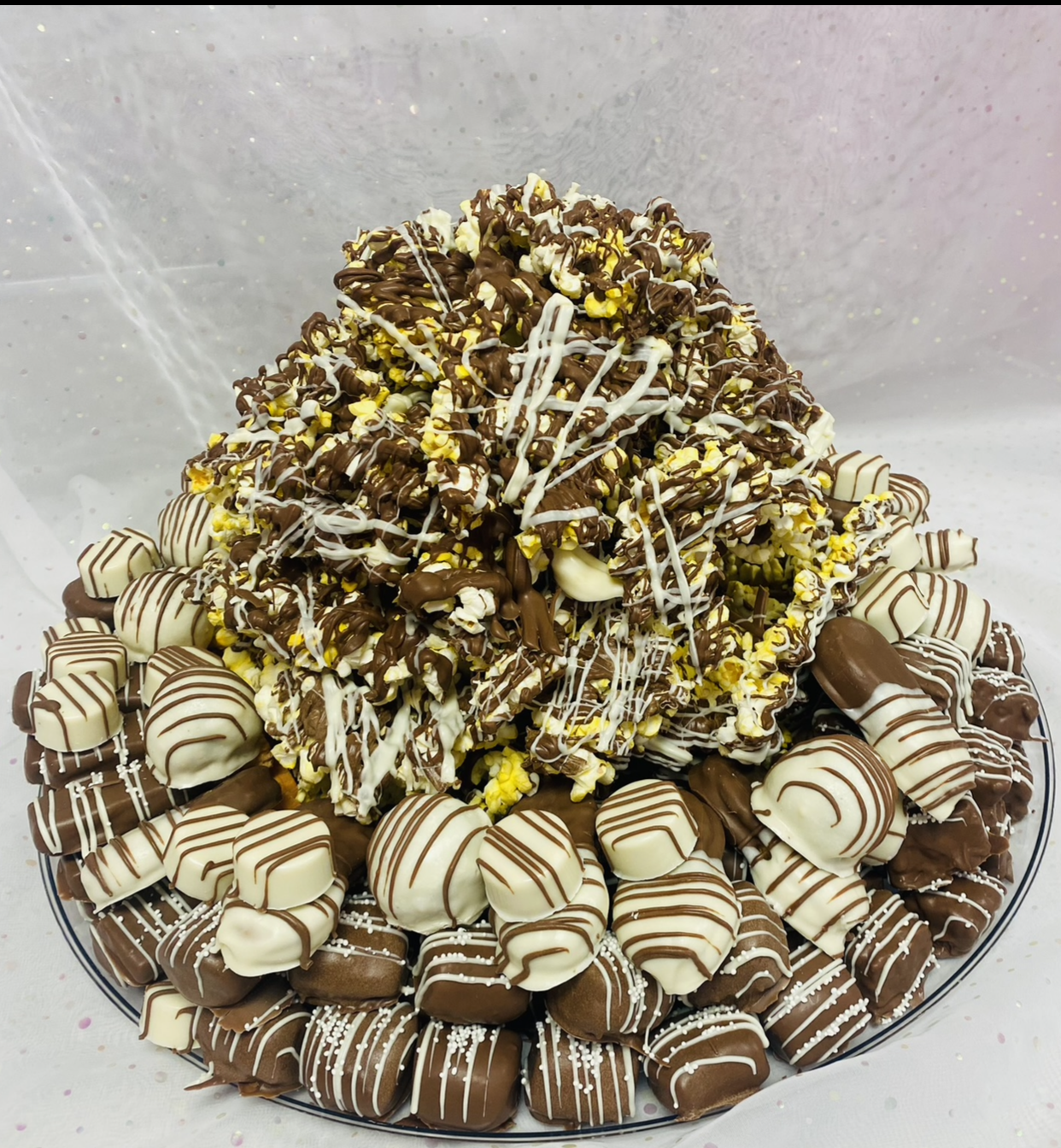 A large platter of chocolate covered cookies and candy.
