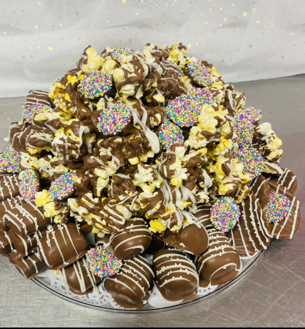 A platter of cookies and other treats on top of a table.