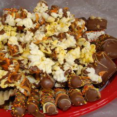 A red plate topped with lots of different types of candy.