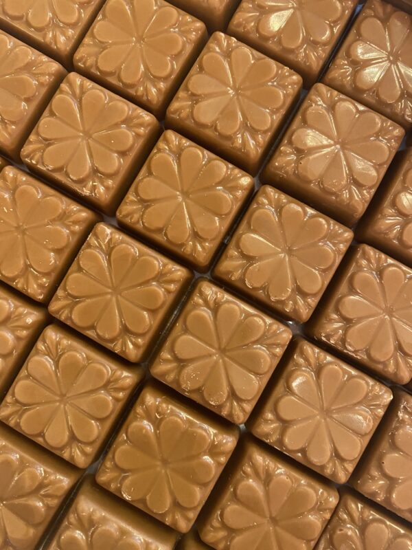 A close up of some brown tiles with flowers