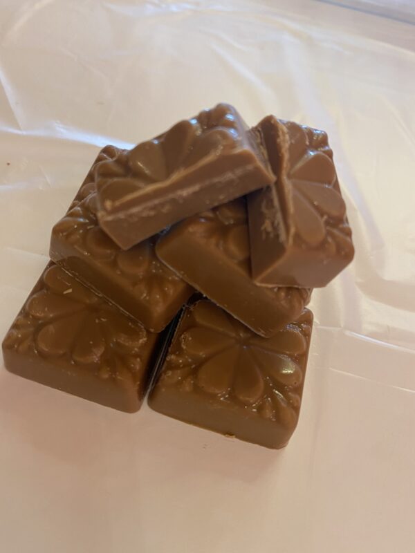 A close up of some chocolate squares on top of a table