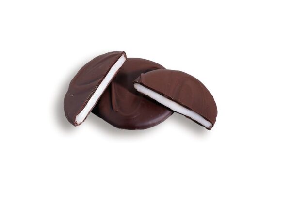 A chocolate covered sandwich cookie with one bite taken out of it.