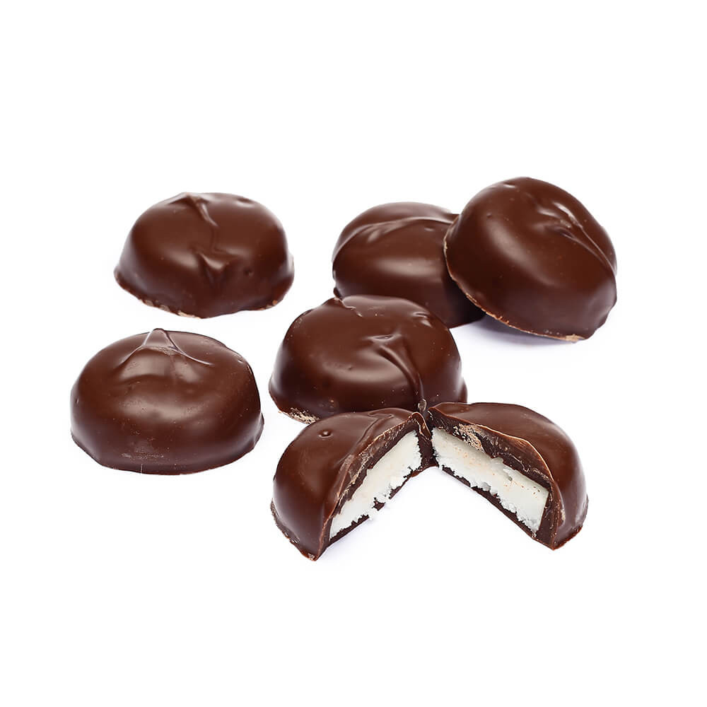 A group of chocolate covered cookies with one cut in half.