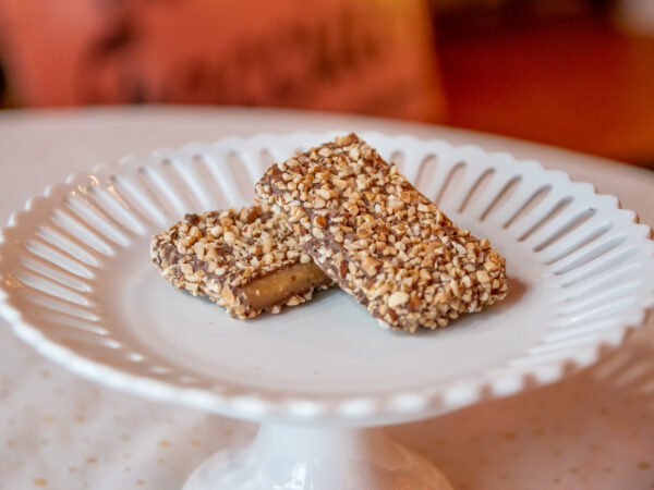 A white plate with two pieces of food on it.