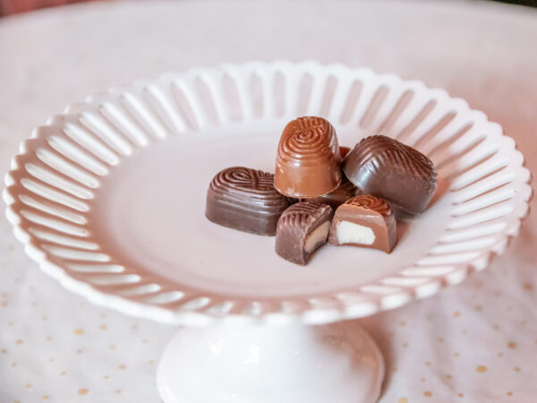 A white plate with chocolate candies on it