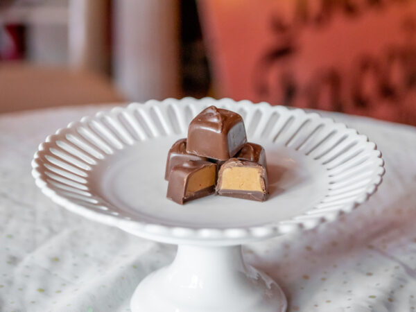 A white plate with some chocolate covered candy on it