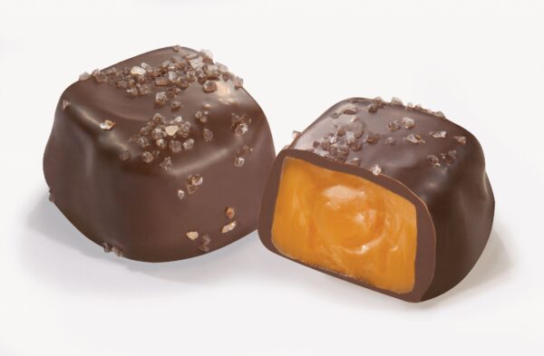 A close up of two chocolate covered candies